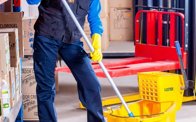 Janitor mopping a warehouse floor